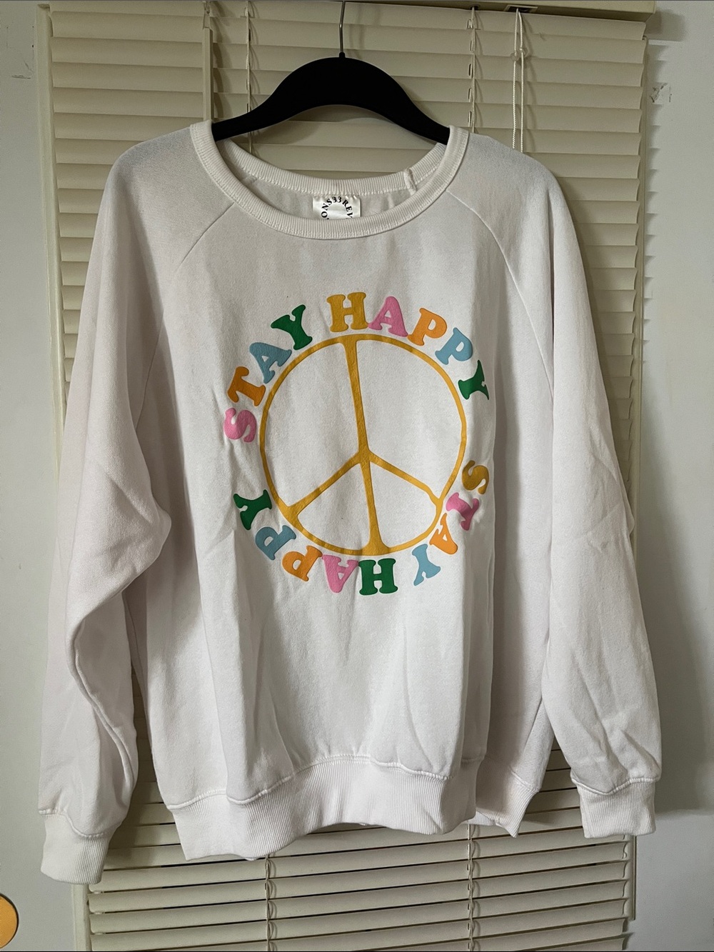 Inspire White Sweatshirt with Yellow Peace Sign and Multicolor 'Stay Happy' Text